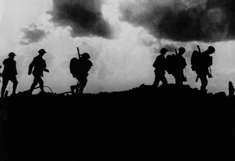British troops in silhouette march towards trenches near Ypres at the Western Front during the First World War.  In the first Battle of Ypres, October 1914, German forces failed to reach the English Channel ports but the Allied counter-attack failed.  Poison gas was employed for the first time in April 1915 by the German army at the second Battle of Ypres.  The final Battle of Ypres between July-November 1917 results in Allied forces capturing Passchendaele. Ypres, Belgium [?]